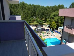 a balcony with a view of a pool and a parking lot at Hotel Nascente in Riccione