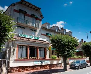 a hotel dolezil with a car parked in front of it at Logis Hotel Le Cerf in Briare