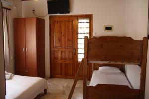 a bedroom with two beds and a bunk bed at Patroudis House in Skala Rachoniou
