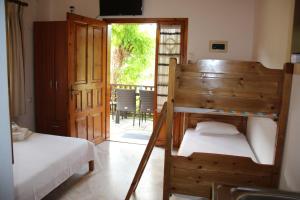 a bedroom with two bunk beds and a door to a patio at Patroudis House in Skala Rachoniou
