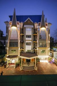 a large building with lights on the front of it at Epsilon Hotel in Ahmedabad