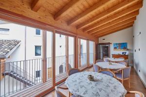 a balcony with tables and chairs and windows at Palazzo Eleonora in Monasterolo del Castello