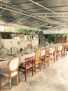 a dining room with a long table and chairs at Olive Manor Guest House in Newcastle