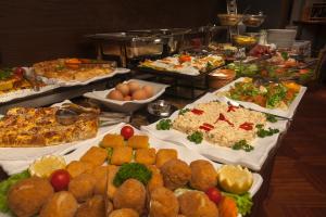 a buffet filled with lots of different types of food at Solun's Riverside Rooms in Skopje