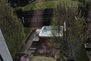 a swimming pool in a garden with bushes at Gasthof Hirschen in Sibratsgfäll