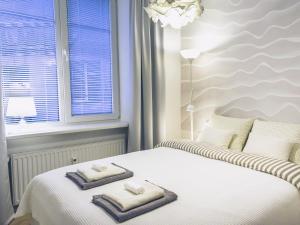 a bedroom with two towels on a bed with a window at No.3 Apartment Link-To-Happiness in Klaipėda