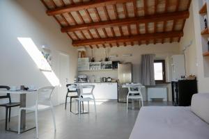a kitchen and living room with tables and chairs at Cerasus B&B in San Marcello
