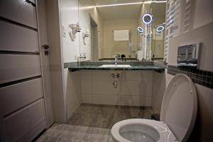 a bathroom with a toilet and a sink at Motelik Grosar Gorlice in Gorlice