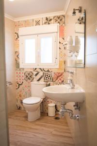 a bathroom with a toilet and a sink at La Casa Del Recreo in Cómpeta +56 photos