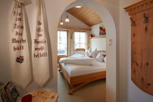 a bedroom with a bed and an arched doorway at Gintherhof in Reutte