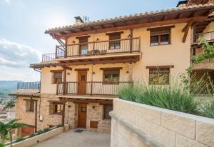 an exterior view of a house with a balcony at Casas Lo Tossal in Beceite