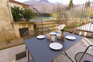 a blue table with white plates and flowers on it at Casa Josa - WelcHome in Cannobio