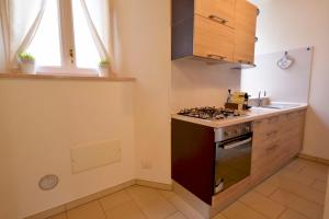 a kitchen with a stove and a sink at Casa Josa - WelcHome in Cannobio