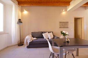 a living room with a couch and a table at Casa Josa - WelcHome in Cannobio