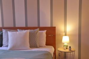 a bedroom with a bed and a lamp on a table at Casa Josa - WelcHome in Cannobio