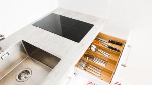 a kitchen with a sink and a tv on a counter at Vironkatu 3 in Helsinki