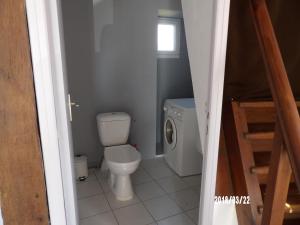 a small bathroom with a toilet and a staircase at 17 rue des blanchards in Clam