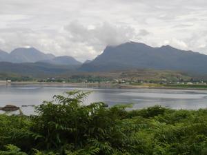 
a large body of water with mountains at Myrtle Bank Hotel in Gairloch
