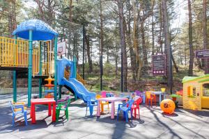 a playground with tables and chairs and a slide at Apartamenty w Marina Jastrzębia Góra in Jastrzębia Góra