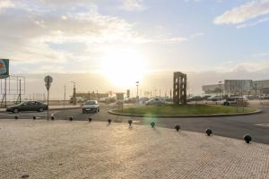 a roundabout in a city with cars on a road at Apartamento Latino Coelho in Póvoa de Varzim