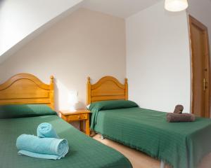 Кровать или кровати в номере Hostal Los Calatravos