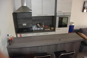 a kitchen with white cabinets and a counter top at Apartment Velcom in Moravske-Toplice