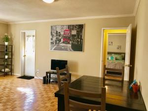 a living room with a table and a red bus on the wall at Downtown 1 Bedroom Apt 20L in Atlanta