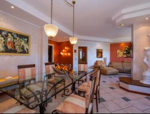 a living room with a glass table and chairs at Lo Specchio Sul Lago - The House Of Travelers in Como