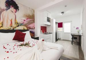 a bedroom with a white bed and a painting on the wall at Wembley Park Hotel in London