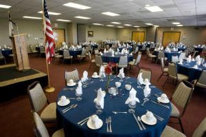 a room with blue tables and chairs and a flag at Highland House in Snowshoe