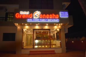 a building with a sign for a sushi curry party restaurant at Hotel Grand Ganesha in Ganpatipule