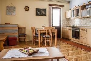 a kitchen with a table and a dining room at Apartment & rooms Grmek in Postojna