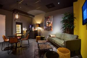 a living room with a couch and a table at Design Hotel Glow in Eindhoven