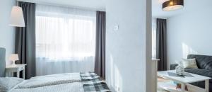 Posteľ alebo postele v izbe v ubytovaní Apartamenty NAVIGATOR-PORT