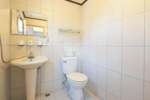 a white bathroom with a toilet and a sink at Happiness Yes Hostel 2 in Luodong +22 photos