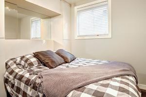 a bedroom with a bed with a blanket on it at Condo 09 Chemin des Abruzzes by Les Chalets Alpins in Stoneham