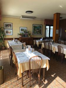 una fila di tavoli in un ristorante con tovaglia bianca di Al Pontesel a Garda