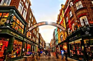 a group of people walking down a street with buildings at Soho Apartment Sleeps 4, Covent Garden & Leicester Square in London