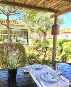 a table with plates and silverware on top of a table at Quinta da Lua in Tavira