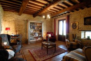 a living room with a couch and chairs and a table at Genius Loci Country Inn in Bevagna