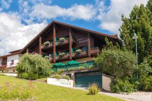 a building with a balcony on top of it at Garni Ingrid in Dobbiaco