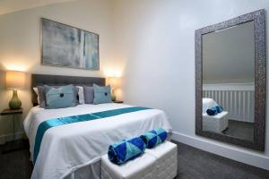 a bedroom with a large bed and a mirror at Modern Loft wQueen Loft Steps to Beach in Hollywood