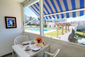 a dining room with a table and a large window at The Moon Studio by Hello Homes Sitges in Sitges