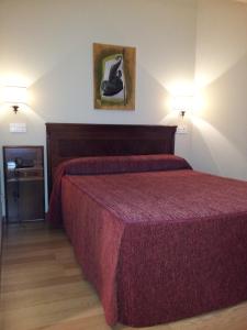מיטה או מיטות בחדר ב-Hotel Begoña