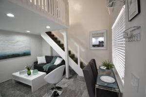 a living room with a staircase and a couch at Loft wqueen loft beach steps in Hollywood