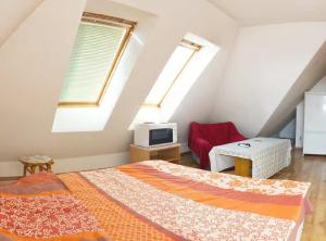 a attic bedroom with two beds and a tv at Stay Nexus near Airport in Sofia