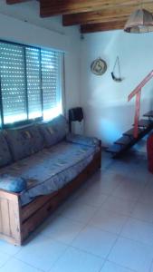a living room with a couch in a room at Departamento carlos paz in Villa Carlos Paz