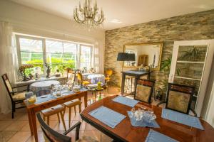 a dining room with a table and chairs in a room at Haus Waldwiese in Hahnenklee-Bockswiese