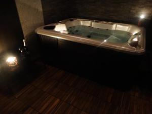 a bathroom with a tub in a dark room at Agriturismo La Terrazza in Valfabbrica +81 photos