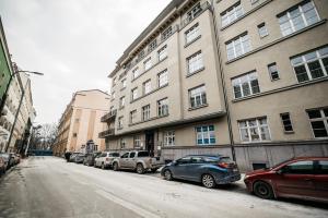 a street with cars parked in front of a building at Penthouse Skyline by LoftAffair in Krakow